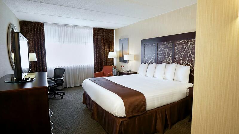 King bed with plush pillows.